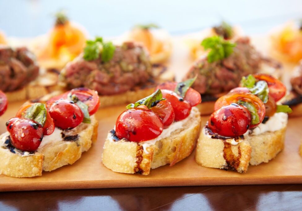 Bruschetta with cheese, tomatoes and foie gras pate